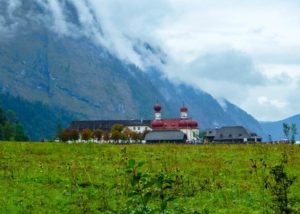 Die Kirche Sankt Bartholomä vor den hohen Bergen des Nationalparks Berchtesgaden.